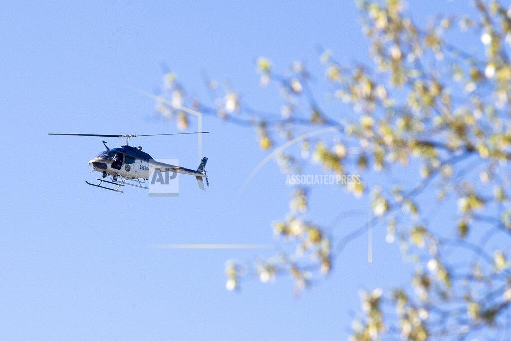 Brianna Paciorka A law enforcement helicopter flies over the area of Austin-East Magnet High School after a reported shooting Monday, April 12, 2021. Authorities say multiple people including a police officer have been shot at the school. (Brianna Paciorka/Knoxville News Sentinel via AP)