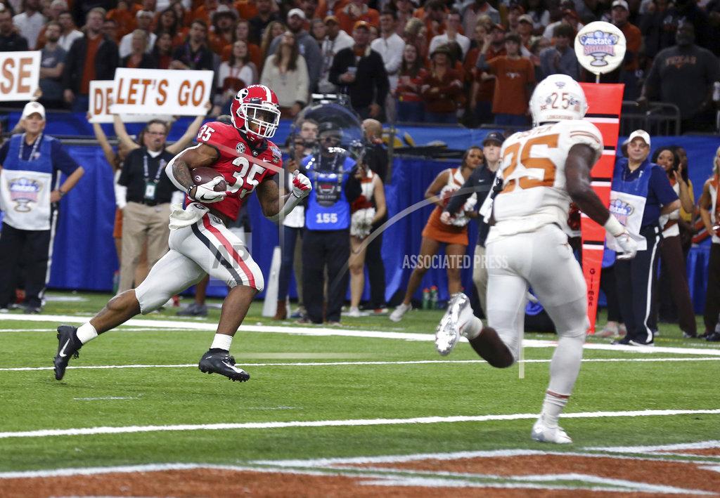 Rusty Costanza Georgia running back Brian Herrien (35) runs for a touchdown as Texas defensive back B.J. Foster (25) moves toward him during the first half of the Sugar Bowl NCAA college football game in New Orleans, Tuesday, Jan. 1, 2019. (AP Photo/Rusty Costanza)