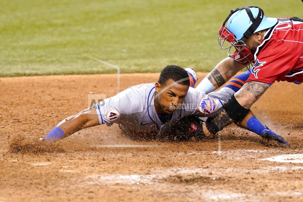 Lynne Sladky New York Mets' Johneshwy Fargas, left, is tagged out at the plate by Miami Marlins catcher Sandy Leon during the 12th inning of a baseball game Friday, May 21, 2021, in Miami. The Mets won 6-5 in 12 innings. (AP Photo/Lynne Sladky)