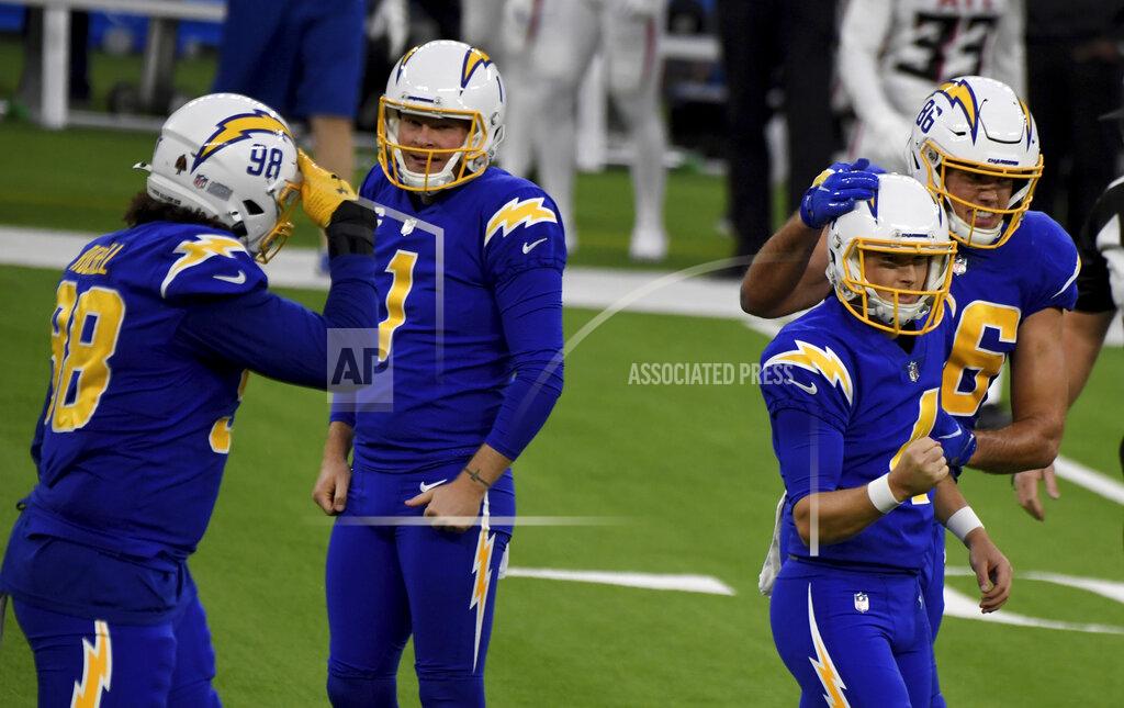 Kicker Mike Badgley, right, celebrates with teammate Hunter Henry after kicking the game-winning 43-yard field goal to defeat the Atlanta Falcons during an NFL football game in Inglewood on Sunday, Dec. 13, 2020. (Keith Birmingham/The Orange County Register via AP)