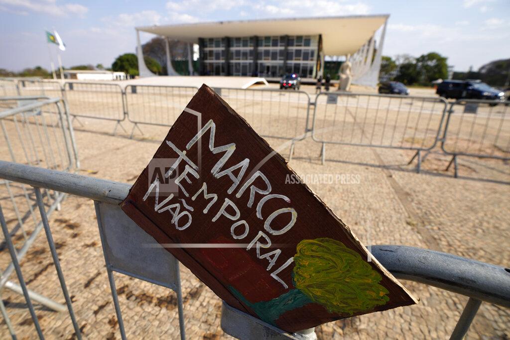 Eraldo Peres A sign written in Portuguese that reads "Timeframe No," hangs from a barricade after the Supreme Court judges' decision to suspend the vote that defines the demarcation of Indigenous lands, during a protest in front of the Supreme Court building, in Brasilia, Brazil, Wednesday, Sept. 15, 2021. (AP Photo/Eraldo Peres)