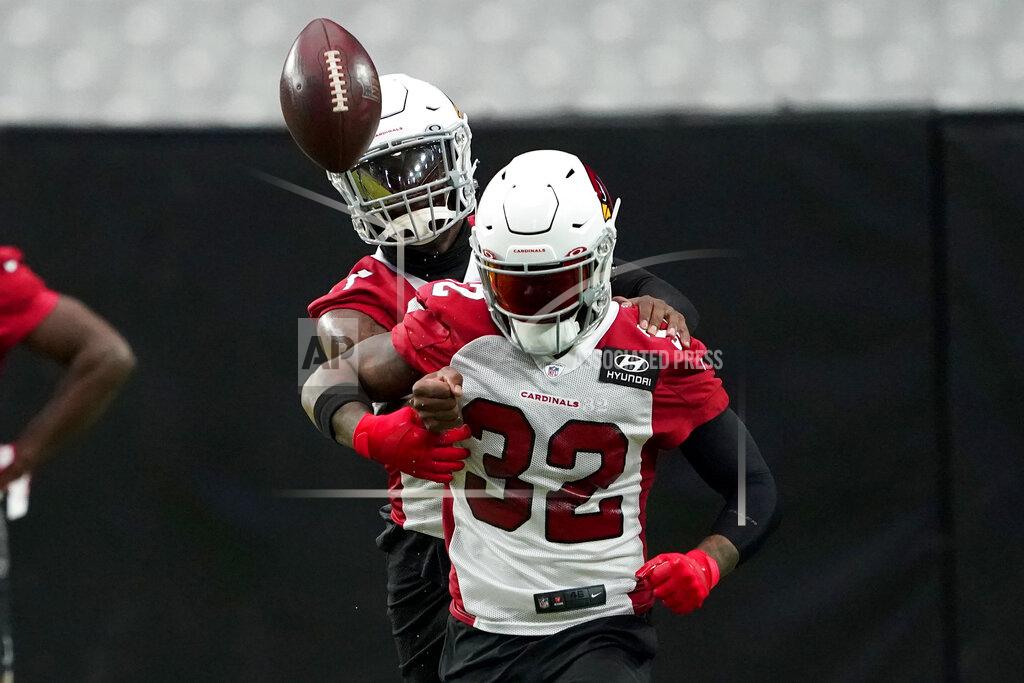 Matt York Arizona Cardinals' Patrick Peterson strips the ball away from Budda Baker (32) during an NFL football training camp Friday, Aug. 14, 2020, in Glendale, Ariz. (AP Photo/Matt York)