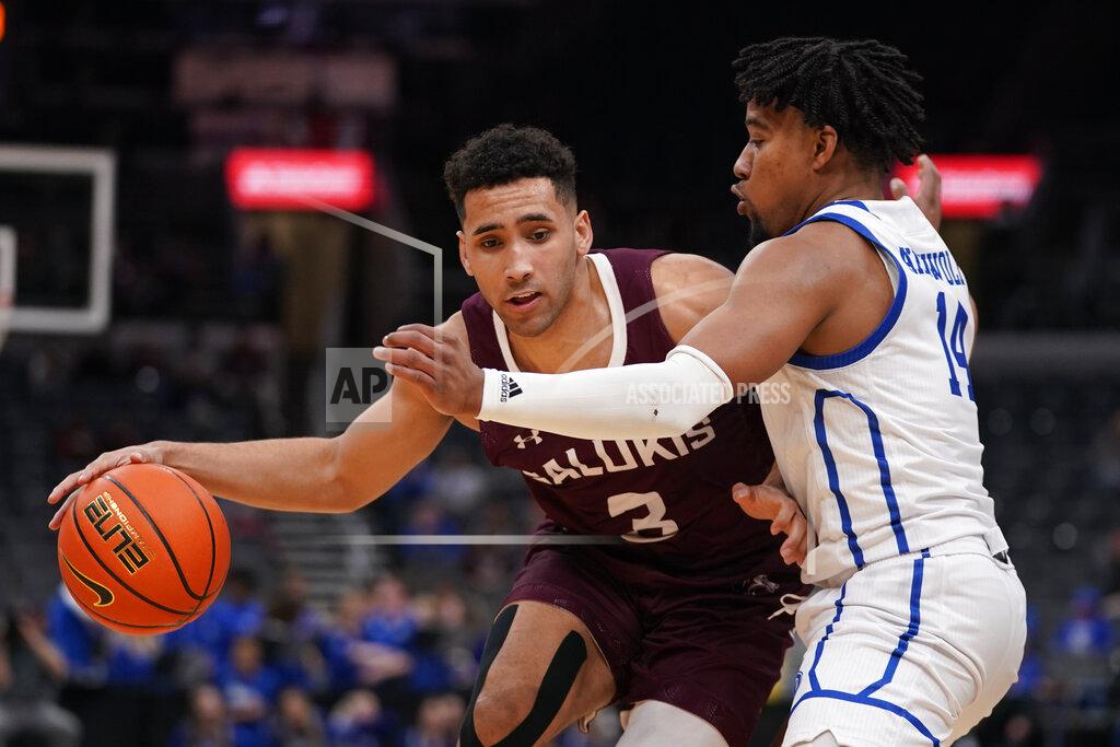 Jeff Roberson Southern Illinois' Dalton Banks (3) dribbles as Drake's Ayo Akinwole (14) defends during the second half of an NCAA college basketball game in the quarterfinal round of the Missouri Valley Conference tournament Friday, March 4, 2022, in St. Louis. (AP Photo/Jeff Roberson)