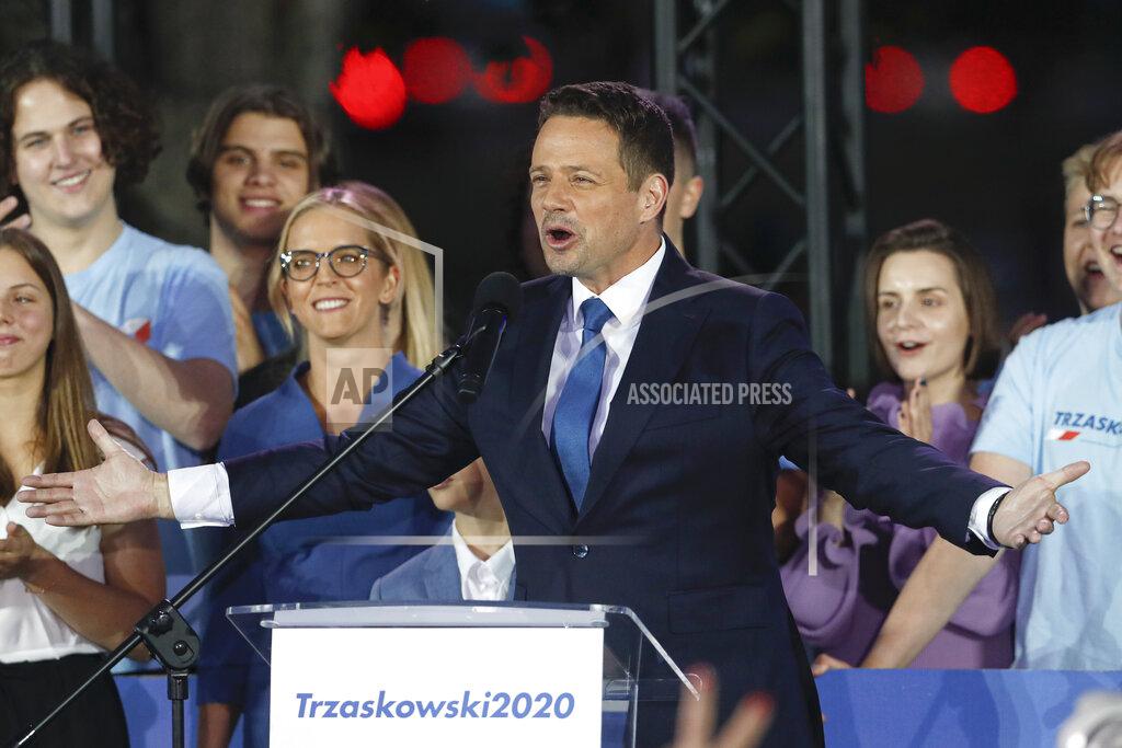 Petr David Josek Presidential candidate Rafal Trzaskowski gestures while addressing supporters at the end of the election day in Warsaw, Poland, Sunday, July 12, 2020. Voting ended in Poland's razor-blade-close presidential election runoff between the conservative incumbent Andrzej Duda and liberal, pro-European Union Warsaw Mayor Rafal Trzaskowski with exit polls showing the election is too close to call. (AP Photo/Petr David Josek)
