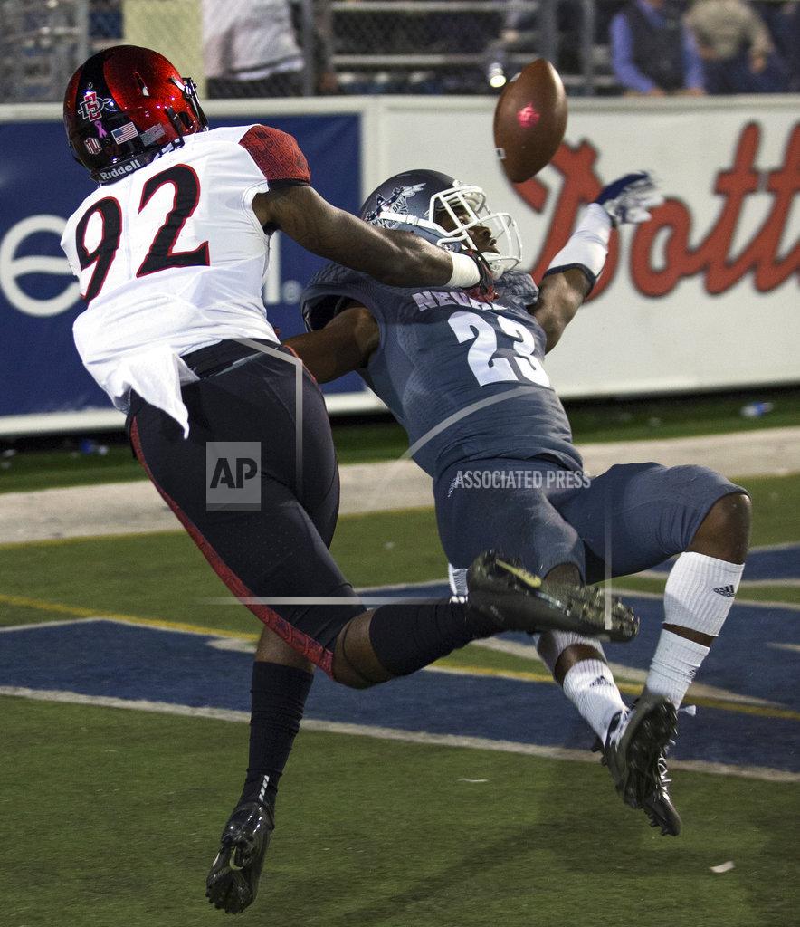 Tom R. Smedes Nevada's Jomon Dotson (23) breaks up a pass to San Diego State's Kobe Smith (92) in the first half of an NCAA college football game in Reno, Nev., Saturday, Oct. 27, 2018. (AP Photo/Tom R. Smedes)