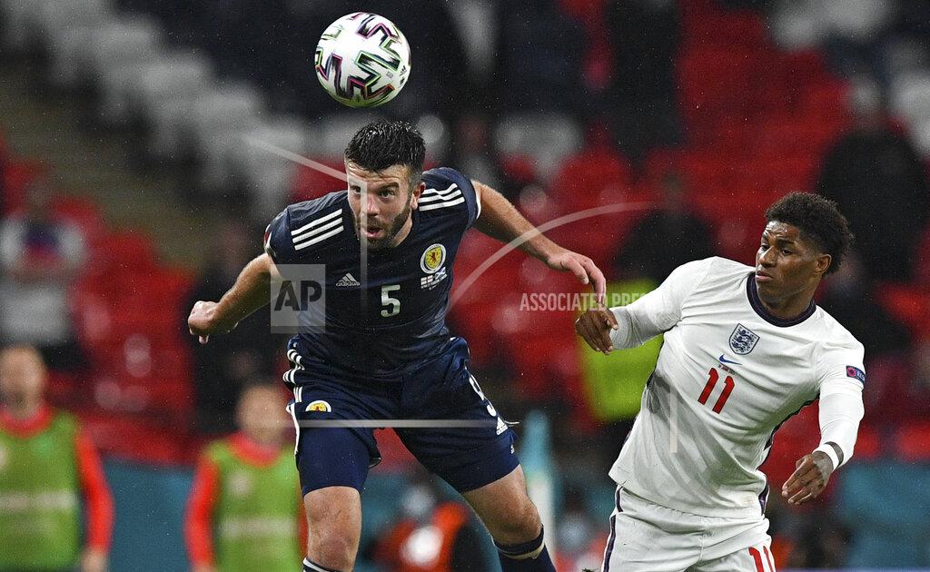 Justin Tallis Scotland's Grant Hanley, left, and England's Marcus Rashford challenge for the ball during the Euro 2020 soccer championship group D match between England and Scotland at Wembley stadium in London, Friday, June 18, 2021. (Justin Tallis/Pool via AP)