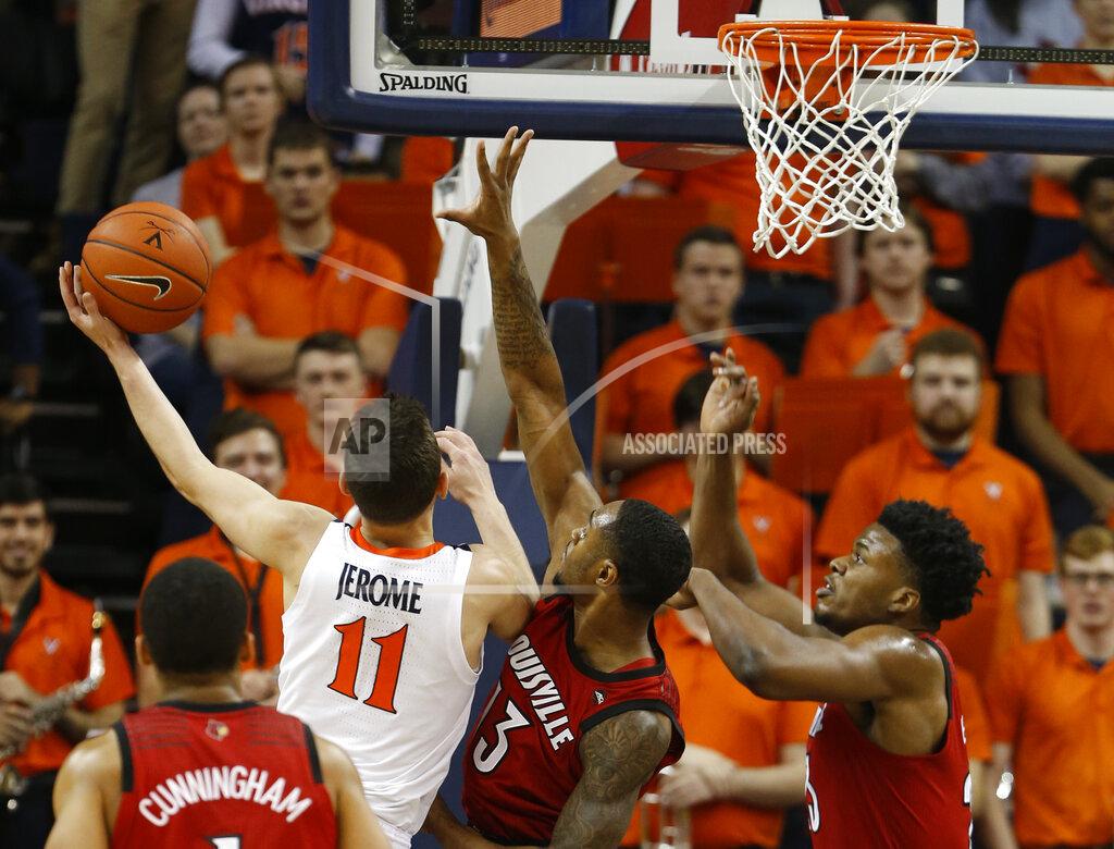 Steve Helber Virginia guard Ty Jerome (11) goes up to shoot as Louisville forward V.J. King (13) and Louisville center Steven Enoch, right defend during the first half of an NCAA college basketball game in Charlottesville, Va., Saturday, March 9, 2019. (AP Photo/Steve Helber)