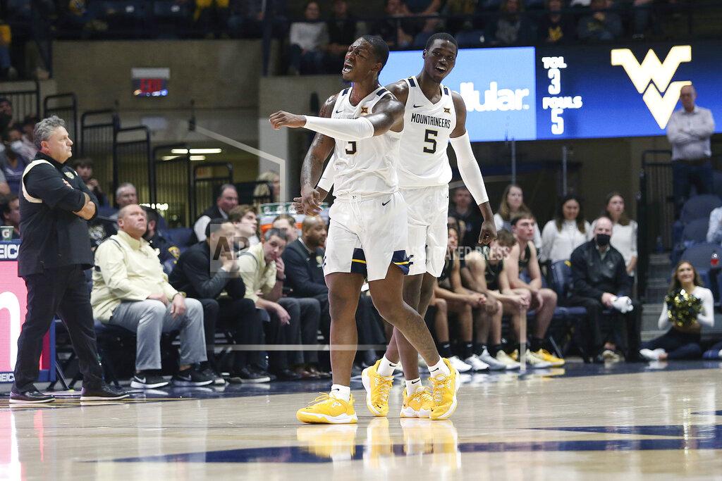 Kathleen Batten West Virginia forwards Gabe Osabuohien (3) and Dimon Carrigan (5) celebrate after a call against Oakland during the second half of an NCAA college basketball game in Morgantown, W.Va., Tuesday, Nov. 9, 2021. (AP Photo/Kathleen Batten)