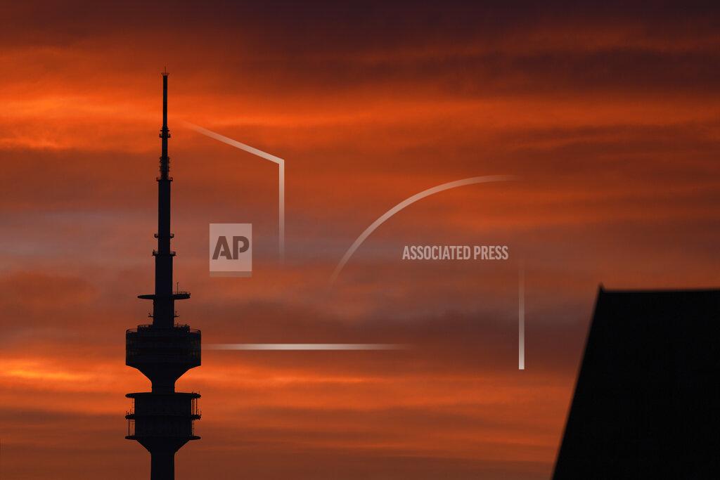 The Olympic TV tower is silhouetted as the sun sets in Munich, Germany, Monday, May 24, 2021. (AP Photo/Matthias Schrader