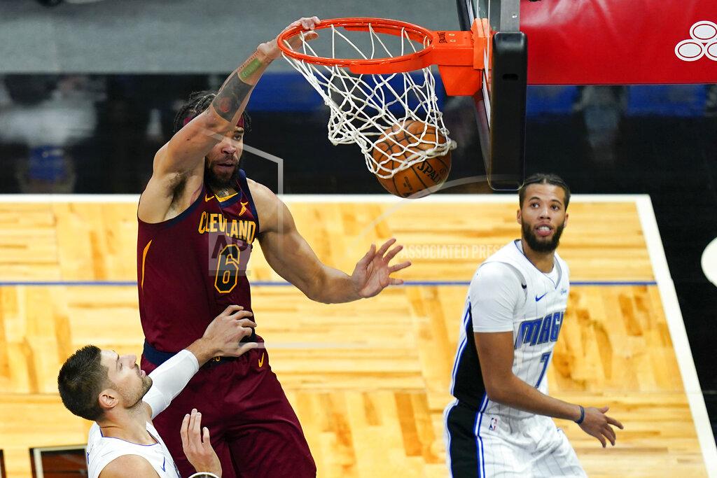 John Raoux Cleveland Cavaliers center JaVale McGee (6) dunks the ball over Orlando Magic center Nikola Vucevic, left, and guard Michael Carter-Williams, right, during the first half of an NBA basketball game, Monday, Jan. 4, 2021, in Orlando, Fla. (AP Photo/John Raoux)