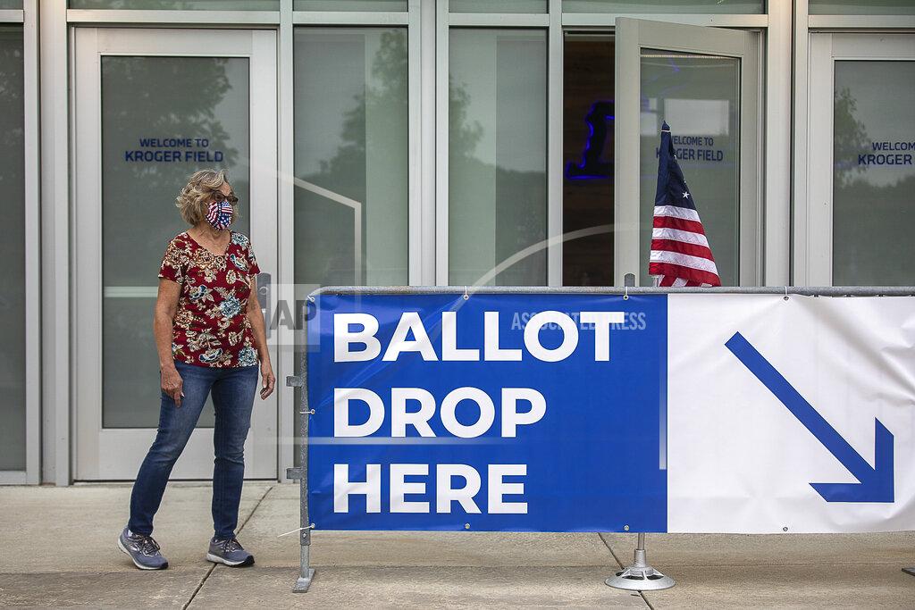 Ryan C. Hermens Poll worker Dolores Louallen directs Fayette County voters where to drop off their absentee ballots at Kroger Field in Lexington, Ky., on Tuesday, June 23, 2020. (Ryan C. Hermens/Lexington Herald-Leader via AP)