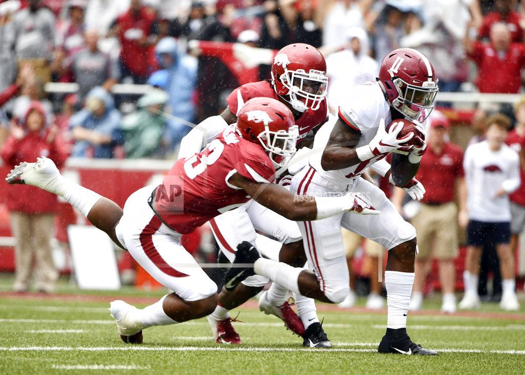 Michael Woods Alabama receiver Henry Ruggs III scoops up a fumble in front of Arkansas defenders Kamren Curl (2) and Dre Greenlaw (23) on his way to scoring a touchdown in the first half of an NCAA college football game Saturday, Oct. 6, 2018, in Fayetteville, Ark. (AP Photo/Michael Woods)