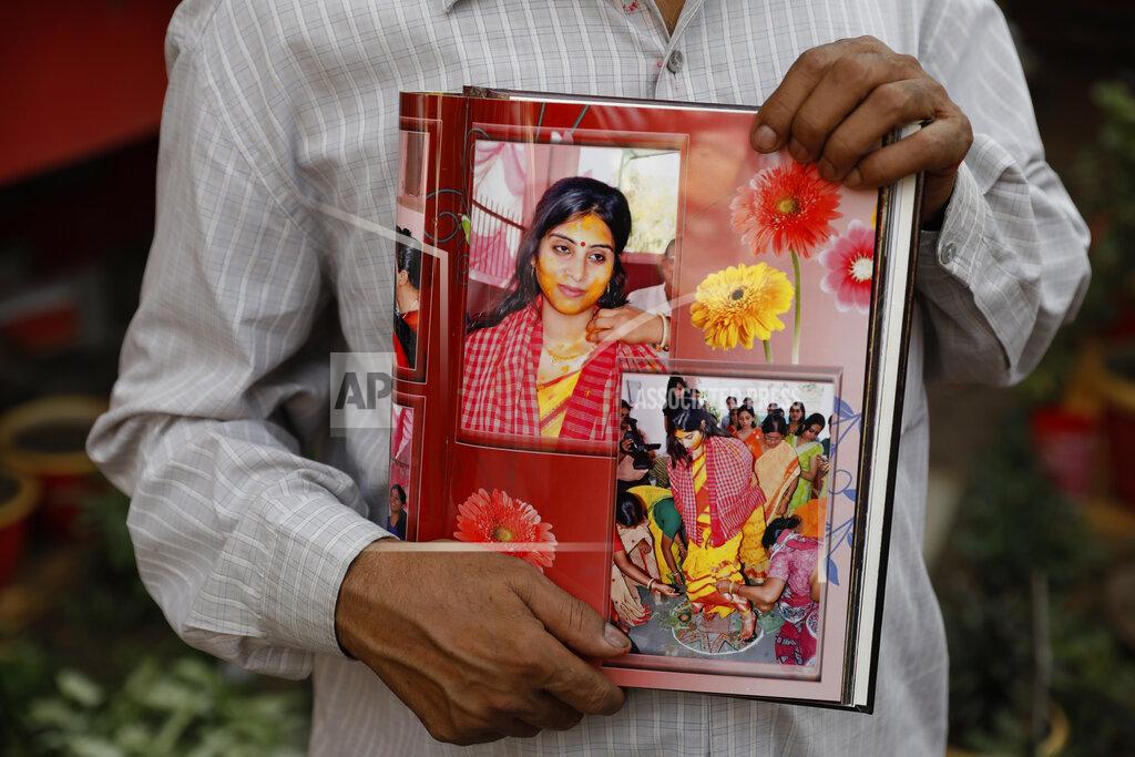 Rajesh Kumar Singh Radha Gobindo Pramanik holds photographs of his daughter who died of COVID-19 in Lucknow, India, Thursday, June 3, 2021. Two months ago Pramanik and his wife threw a party to celebrate their daughter's pregnancy and the upcoming birth of their long-awaited grandchild. Within days, his wife, his daughter and his unborn grandchild were all dead, among the tens of thousands killed as the coronavirus ravaged India in April and May. (AP Photo/Rajesh Kumar Singh)