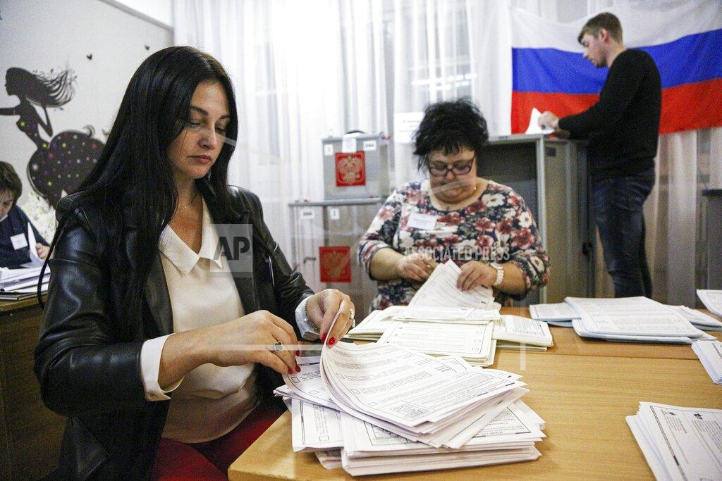 Evgeniy Sofiychuk Members of an election commission count ballots after voting at a polling station after the Parliamentary elections in Nikolayevka village outside Omsk, Russia, Sunday, Sept. 19, 2021. From the Baltic Sea to the Pacific Ocean, Russians across eleven time zones voted Sunday on the third and final day of a national election for a new parliament, a ballot in which the pro-Kremlin ruling party is largely expected to retain its majority after months of relentless crackdown on the opposition. (AP Photo/Evgeniy Sofiychuk)