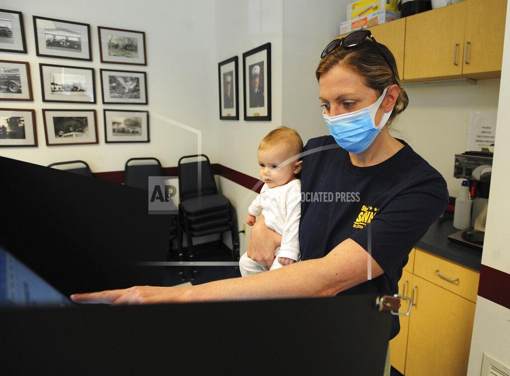 Mark Moran Former Luzerne County District Attorney Stefanie Salavantis, a candidate for Judge of the Luzerne County Court of Common Pleas, holds her daughter, Remington, as she votes in the primary election at the Municipality of Kingston Fire Department, Kingston, Pa., on Tuesday, May 18, 2021. (Mark Moran/The Citizens' Voice via AP)