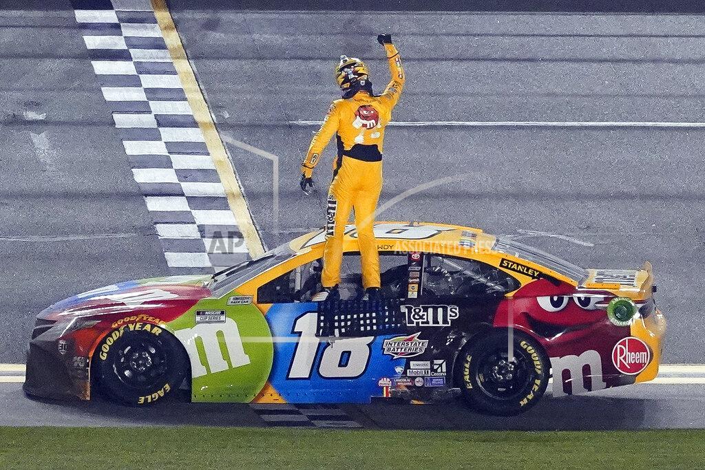 John Raoux Kyle Busch celebrates on the top of his car after winning the NASCAR Clash auto race at Daytona International Speedway, Tuesday, Feb. 9, 2021, in Daytona Beach, Fla. (AP Photo/John Raoux)
