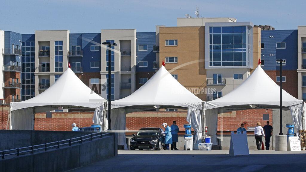 Rick Bowmer Healthcare workers perform COVID-19 Testing at University of Utah's Sugar House Health Center Monday, April 27, 2020, in Salt Lake City. Utah's testing numbers also surpassed 100,000 on Monday, April 27, 2020, with about 4,500 new tests performed. The state is now capable of testing up to 9,000 people daily, but despite the expanded criteria, has been seeing demand under capacity with an average of 4,000 to 6,000 people getting tested daily. (AP Photo/Rick Bowmer)