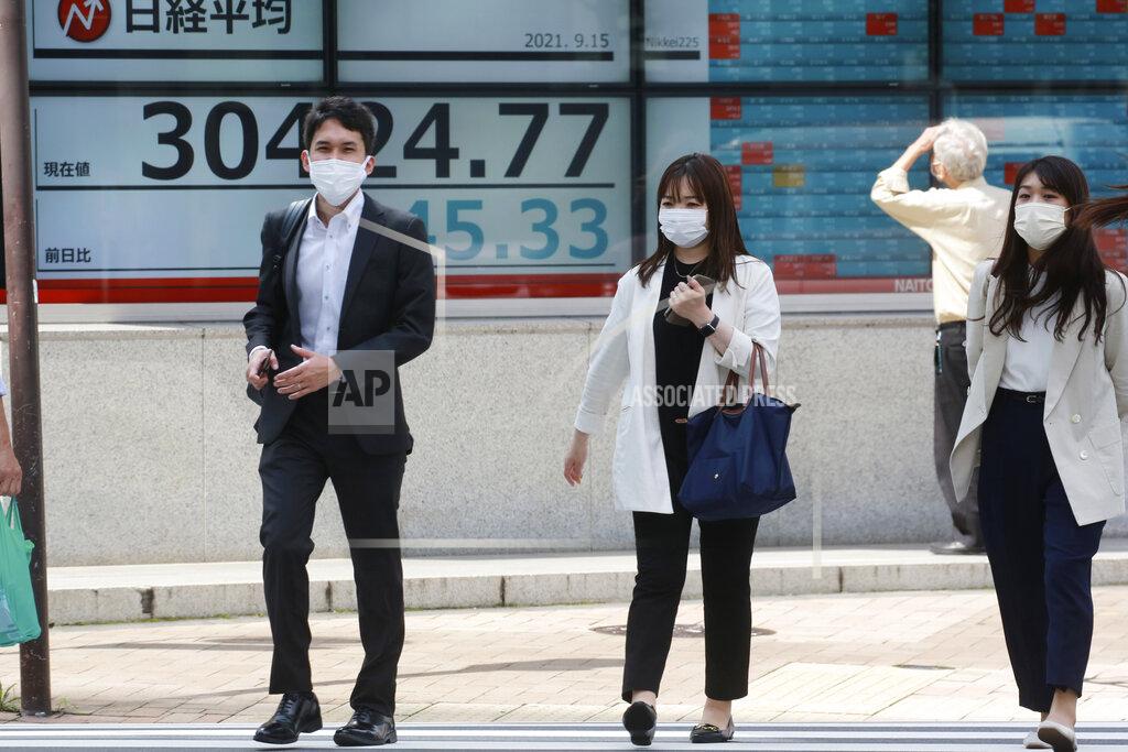 Koji Sasahara People walk by an electronic stock board of a securities firm in Tokyo, Wednesday, Sept. 15, 2021. Asian stock markets followed Wall Street down on Wednesday after U.S. inflation was lower than expected amid unease about the impact of the spread of the coronavirus's delta variant. (AP Photo/Koji Sasahara)