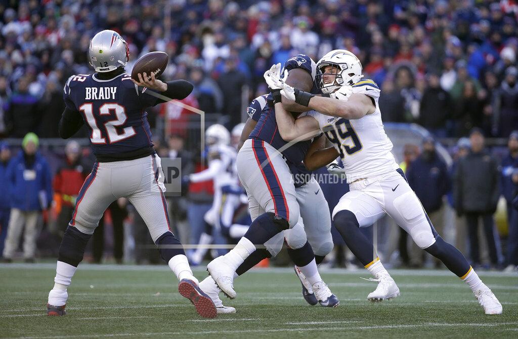Elise Amendola New England Patriots quarterback Tom Brady (12) passes while tackle Marcus Cannon blocks Los Angeles Chargers defensive end Joey Bosa (99) during the first half of an NFL divisional playoff football game, Sunday, Jan. 13, 2019, in Foxborough, Mass. (AP Photo/Elise Amendola)