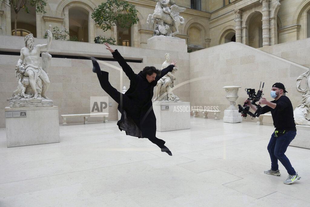 Thibault Camus Dancer Germain Louvet performs during the filming of a commercial, in the Louvre museum, in Paris, Thursday, Feb. 11, 2021. Though empty corridors and vacant galleries are a grim sight for frustrated art-lovers, they are a golden opportunity to do works of renovation, refurbishment and re-ordering that were simply not possible with the around 10 million visitors per year. (AP Photo/Thibault Camus)