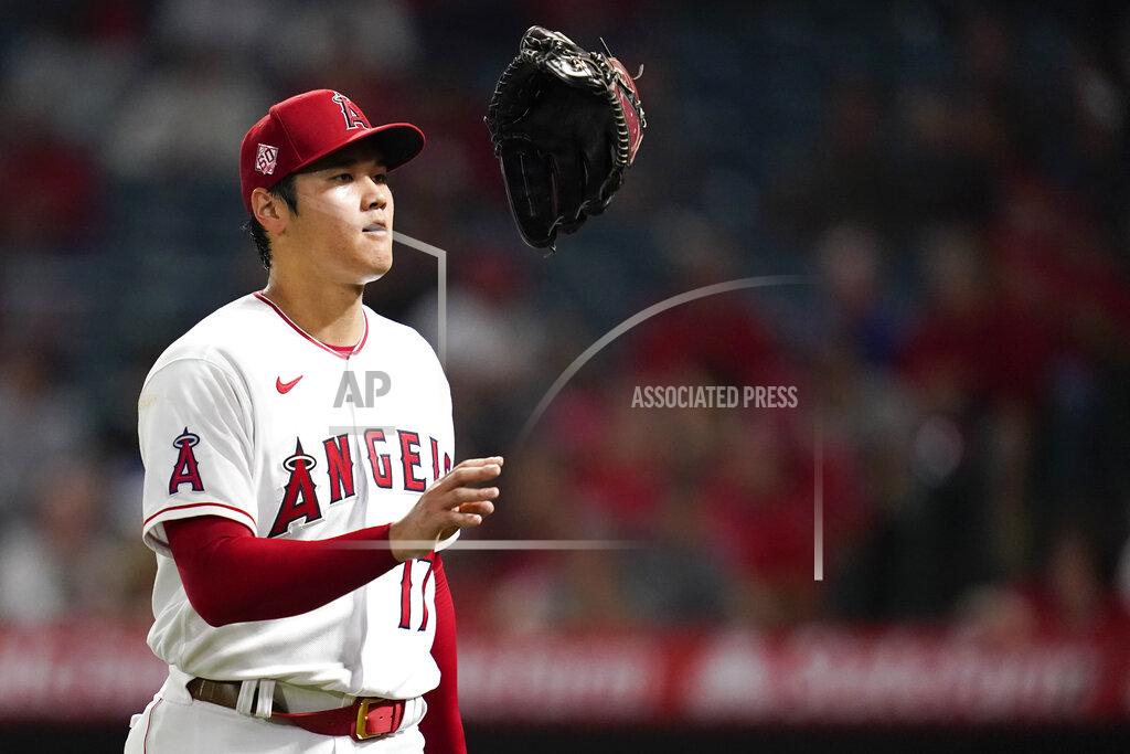 Ashley Landis Los Angeles Angels starting pitcher Shohei Ohtani (17) tosses his glove as he returns to the dugout in the middle of the fourth inning of a baseball game against the Texas Rangers Friday, Sep. 3, 2021, in Anaheim, Calif. (AP Photo/Ashley Landis)