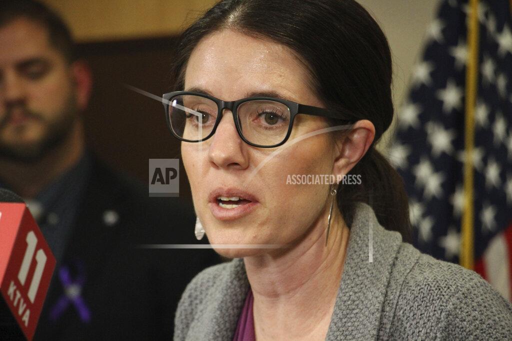 FILE - In this Thursday, March 12, 2020 file photo, Dr. Anne Zink, Alaska's chief medical officer, addresses reporters at a news conference in Anchorage, Alaska. Zink, has become the explainer-in-chief for Alaskans during the coronavirus outbreak, a regular at news conferences who has become known for providing information in a straight-forward, easy-to-understand manner. She’s gotten praise from residents for her approach and inspired a poem from a Juneau city official. (AP Photo/Mark Thiessen, File)