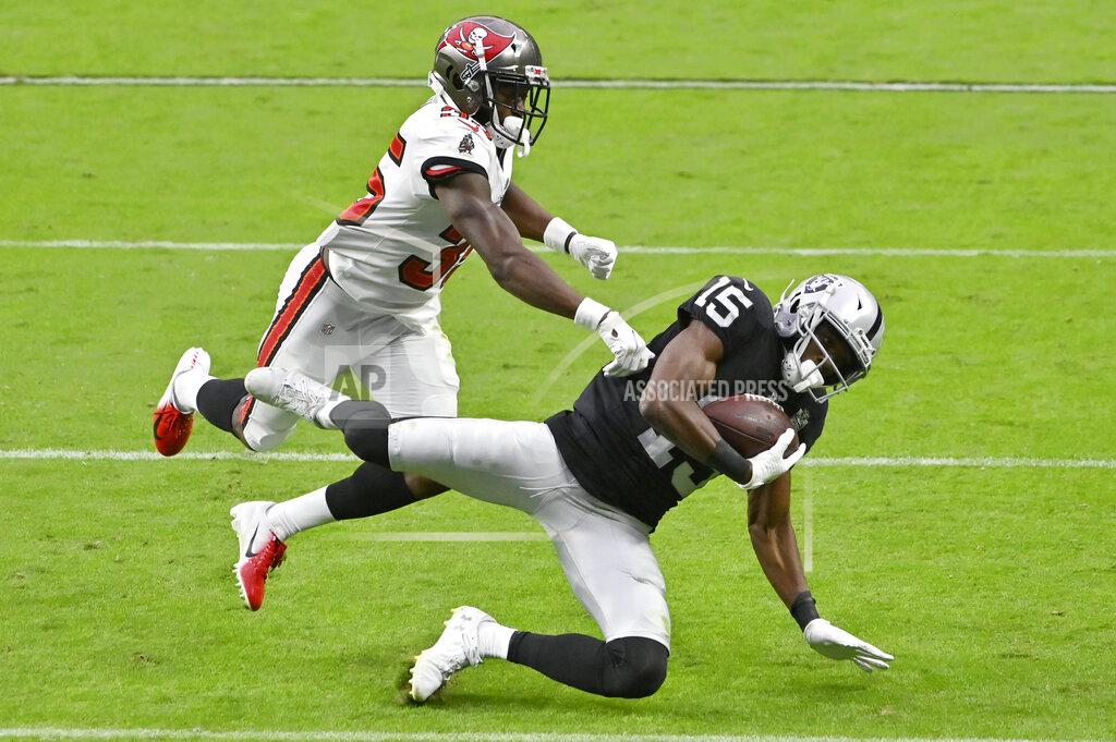 David Becker Las Vegas Raiders wide receiver Nelson Agholor (15) catches a pass over Tampa Bay Buccaneers cornerback Jamel Dean (35) during the second half of an NFL football game, Sunday, Oct. 25, 2020, in Las Vegas. (AP Photo/David Becker)