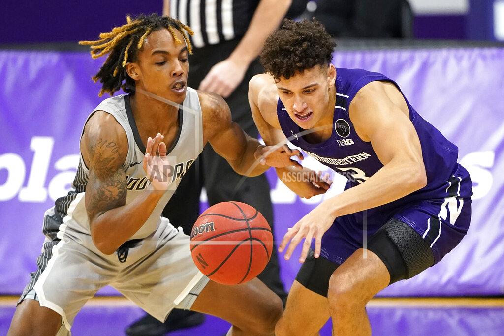 Nam Y. Huh Chicago State guard Rajeir Jones, left, and Northwestern guard Ty Berry battle for a loose ball during the first half of an NCAA college basketball game in Evanston, Ill., Saturday, Dec. 5, 2020. (AP Photo/Nam Y. Huh)