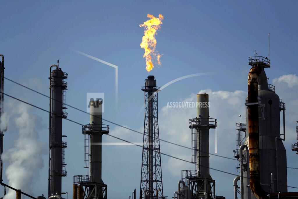 FILE - In this Thursday, Aug. 31, 2017, file photo, a flame burns at the Shell Deer Park oil refinery in Deer Park, Texas. Oil prices are plunging Sunday, March 8, 2020, amid worries that an OPEC dispute will lead a virus-weakened economy to be awash in an oversupply of crude. (AP Photo/Gregory Bull, File)