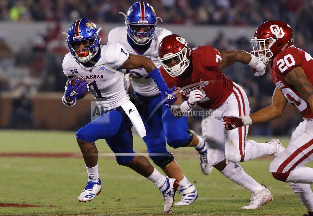Alonzo Adams FILE - In this Nov. 17, 2018, file photo, Kansas running back Pooka Williams Jr. (1) runs ahead of Oklahoma defenders during the first half of an NCAA college football game, in Norman, Okla. Pooka Williams Jr. was selected as the newcomer of the year when the AP All-Big 12 team was announced Friday, Dec. 7, 2018. (AP Photo/Alonzo Adams, File)