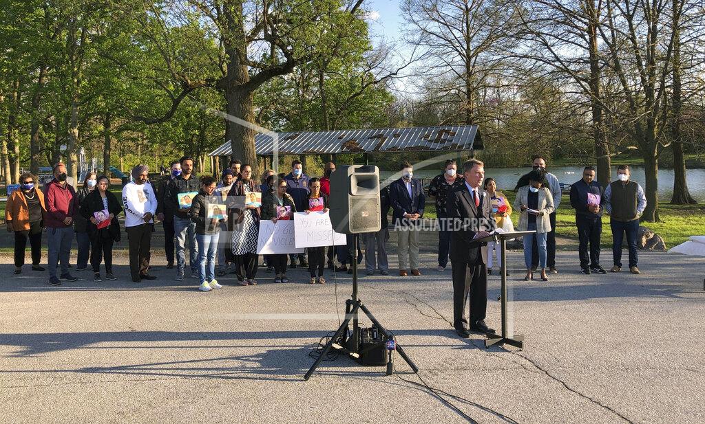 Casey Smith Indianapolis Mayor Joe Hogarth speaks at a vigil Saturday, April 17, 2021 at Krannert Park on Indianapolis’ west side to memorialize the eight people killed in the mass shooting at a FedEx warehouse. Behind him, members of the Sikh community, whose loved ones were killed, hold signs demanding policymakers make gun law reforms in the wake of the shooting. (AP Photo/Casey Smith)