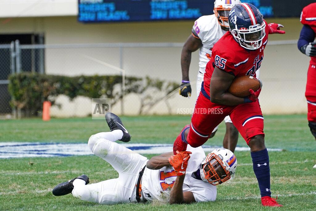 Rogelio V. Solis Jackson State tight end Kyland Richey (85) pulls away from an Edward Waters defender after a pass reception during the first half of an NCAA college football in Jackson, Miss., Sunday, Feb. 21, 2021. The game marked the head coaching debut of Jackson State football coach Deion Sanders. (AP Photo/Rogelio V. Solis)