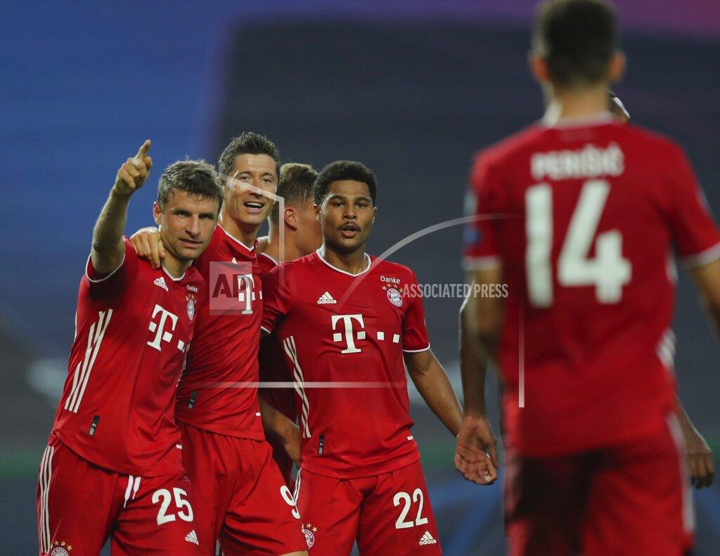Miguel A. Lopes Bayern's Serge Gnabry, right, celebrates his side's second goal with teammates Robert Lewandowski, center, and Thomas Mueller during the Champions League semifinal soccer match between Lyon and Bayern Munich at the Jose Alvalade stadium in Lisbon, Portugal, Wednesday, Aug. 19, 2020. (Miguel A. Lopes/Pool via AP)
