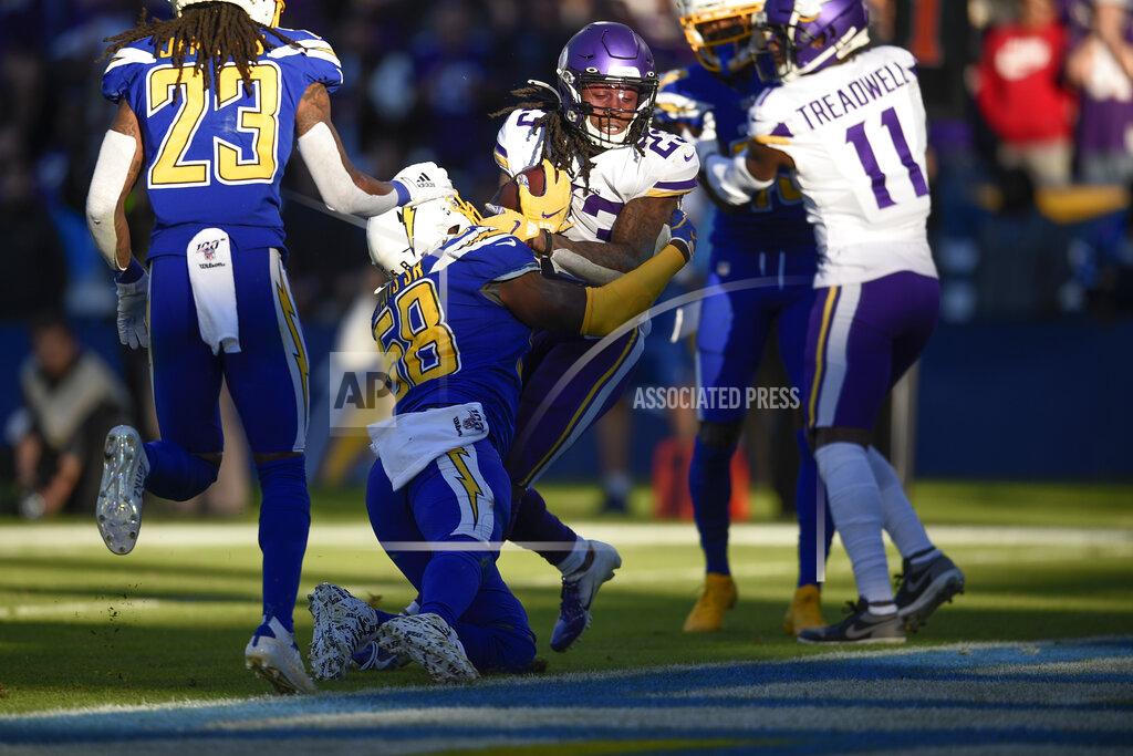 Kelvin Kuo Minnesota Vikings running back Mike Boone, center, scores a touchdown as Los Angeles Chargers outside linebacker Thomas Davis defends during the second half of an NFL football game Sunday, Dec. 15, 2019, in Carson, Calif. (AP Photo/Kelvin Kuo)