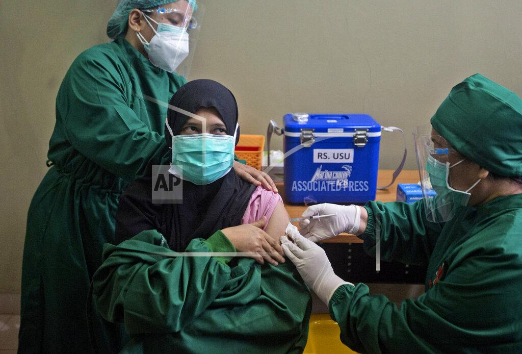 Binsar Bakkara FILE - In this Wednesday, Jan. 20, 2021 file photo, Dr. Lili Rahmawaty, right, gives a shot of COVID-19 vaccine to a colleague at North Sumatra University Hospital in Medan, North Sumatra, Indonesia. The choices are limited for Indonesia, the world's fourth most populous country, and many other low- and middle-income countries clobbered by COVID. Vaccine deployment globally has been dominated by rich countries, which have snapped up 5.4 billion of the 7.8 billion doses purchased worldwide, according to Duke University. (AP Photo/Binsar Bakkara)