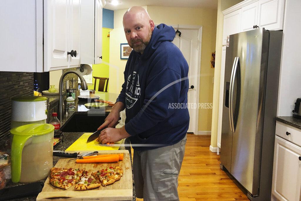 Tammy Webber Kevin Fitzpatrick, an emergency room nurse at Hurley Medical Center in Flint, Mich., prepares dinner after his shift Thursday, Oct. 29, 2020. Fitzpatrick said some nurses have quit in recent weeks even as the coronavirus resurges, putting more strain on remaining nurses. As the coronavirus pandemic surges across the nation and infections and hospitalizations rise, medical administrators are scrambling to find enough nursing help — especially in rural areas and at small hospitals. (AP Photo/Tammy Webber)