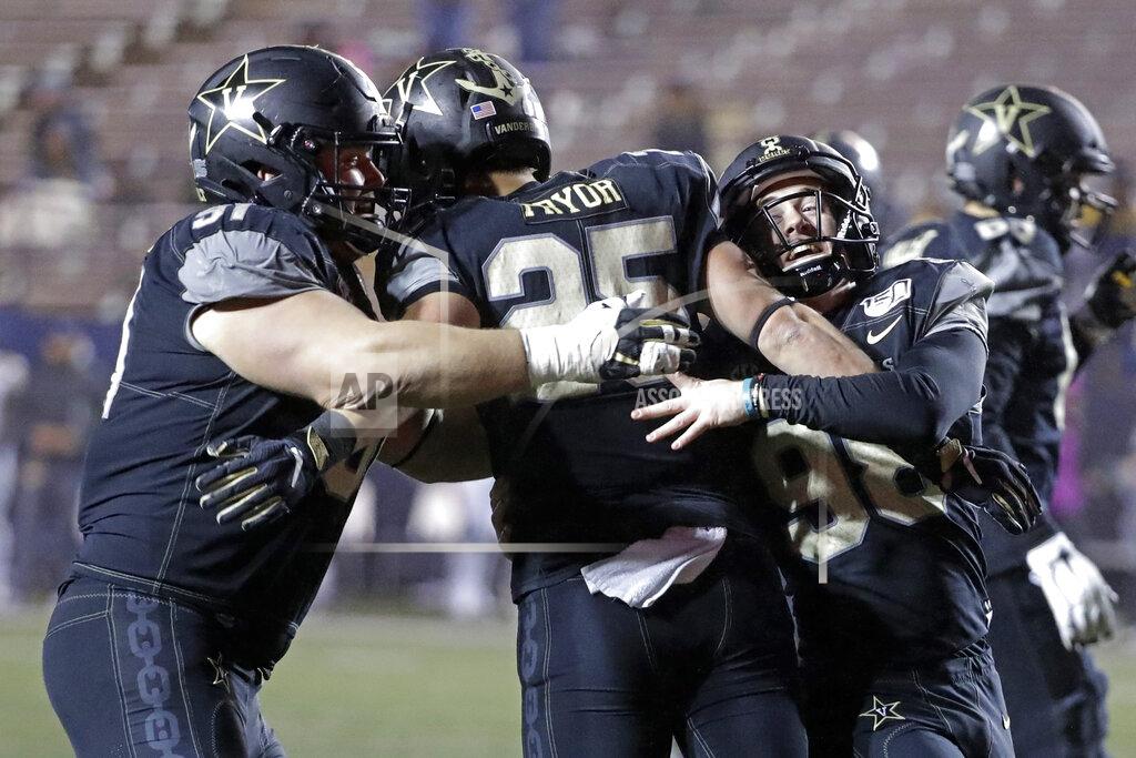 Mark Humphrey Vanderbilt running back Mitchell Pryor (25) celebrates with Drew Birchmeier, left, and Ryley Guay, right, after Pryor ran 31 yards for a touchdown against ETSU in the second half of an NCAA college football game Saturday, Nov. 23, 2019, in Nashville, Tenn. Vanderbilt won 38-0. (AP Photo/Mark Humphrey)