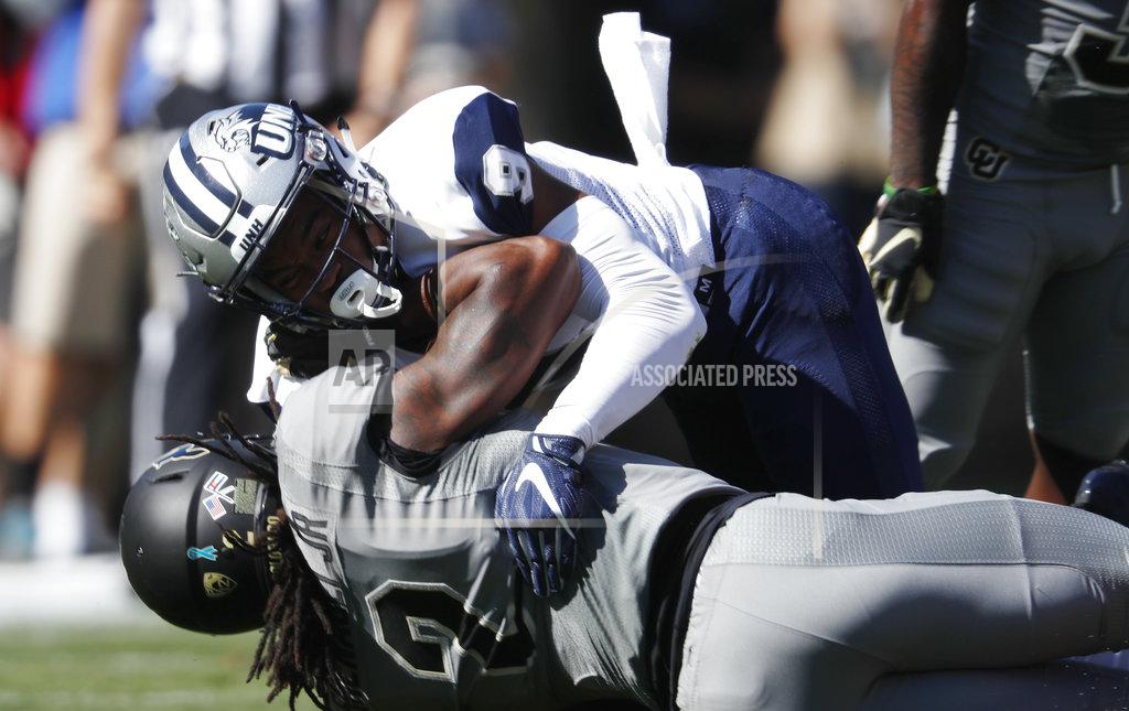 David Zalubowski New Hampshire cornerback Isiah Perkins, top, tackles Colorado wide receiver Laviska Shenault Jr. after a short gain in the first half of an NCAA college football game Saturday, Sept. 15, 2018, in Boulder, Colo. (AP Photo/David Zalubowski)