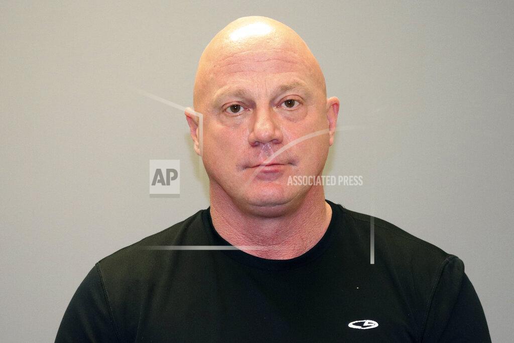 Uncredited This undated photo provided by the Grapevine Texas Police Department shows, Larry Rendall Brock Jr. During the deadly riot at the U.S. Capitol on Wednesday, Jan. 6, 2021, Brock was photographed on the Senate floor wearing a helmet and heavy vest and carrying zip-tie handcuffs. The retired Air Force officer was arrested in Texas and charged Sunday, Jan. 10 in federal court in the District of Columbia. (GrapevineTexas Police Department via AP)