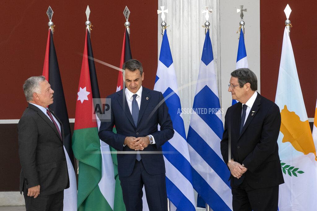 Yorgos Karahalis Jordan's King Abdullah II, left, Greece's Prime Minister Kyriakos Mitsotakis, center, and Cyprus' President Nikos Anastasiades pose for a group photo ahead of their meeting in Athens, on Wednesday, July 28, 2021. Greece hosts a one-day trilateral meeting of the three leaders. (AP Photo/Yorgos Karahalis)