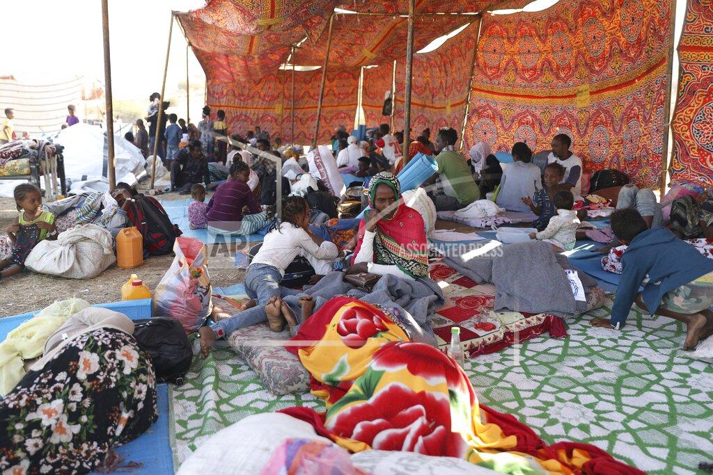 Ethiopian refugees gather in Qadarif region, easter Sudan, Friday, Nov 20, 2020. Thousands of Ethiopians fled the war in Tigray region into Sudan. (AP Photo/Marwan Ali)