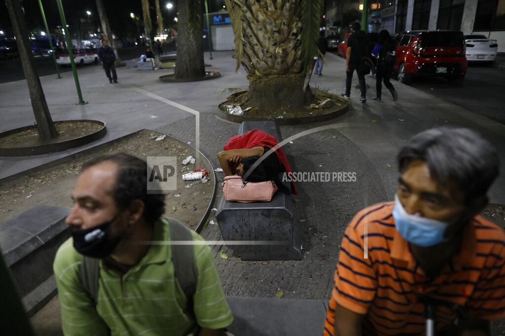 Rebecca Blackwell A sex worker naps on a bench as she waits for clients outside the Revolution subway station, in Mexico City, Saturday, March 13, 2021. Despite the common perception that sex work equals easy money, many of the longtime sex workers struggle to stay housed and to afford enough to eat, particularly since profit margins have plummeted amid the coronavirus pandemic, with more competition, fewer clients, and increased hotel prices. (AP Photo/Rebecca Blackwell)