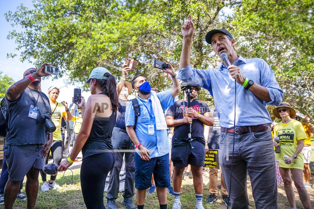 Ricardo B. Brazziell Former Democratic congressman and presidential candidate Beto O'Rourke speaks to the crowd during a break on the march with his voter outreach organization Powered by People are partnering with Rev. William Barber and the Poor People's Campaign as they gathered together on the side of the road in Round Rock, Texas to participate in a Selma-style march for democracy from Georgetown, Texas to the Texas State Capitol in downtown Austin. On Wednesday, July 28, 2021 the group made a stop at Good Hope church in Round Rock and will end with a rally at the Capitol at 10 am on July 31st. (Ricardo B. Brazziell/Austin American-Statesman via AP)