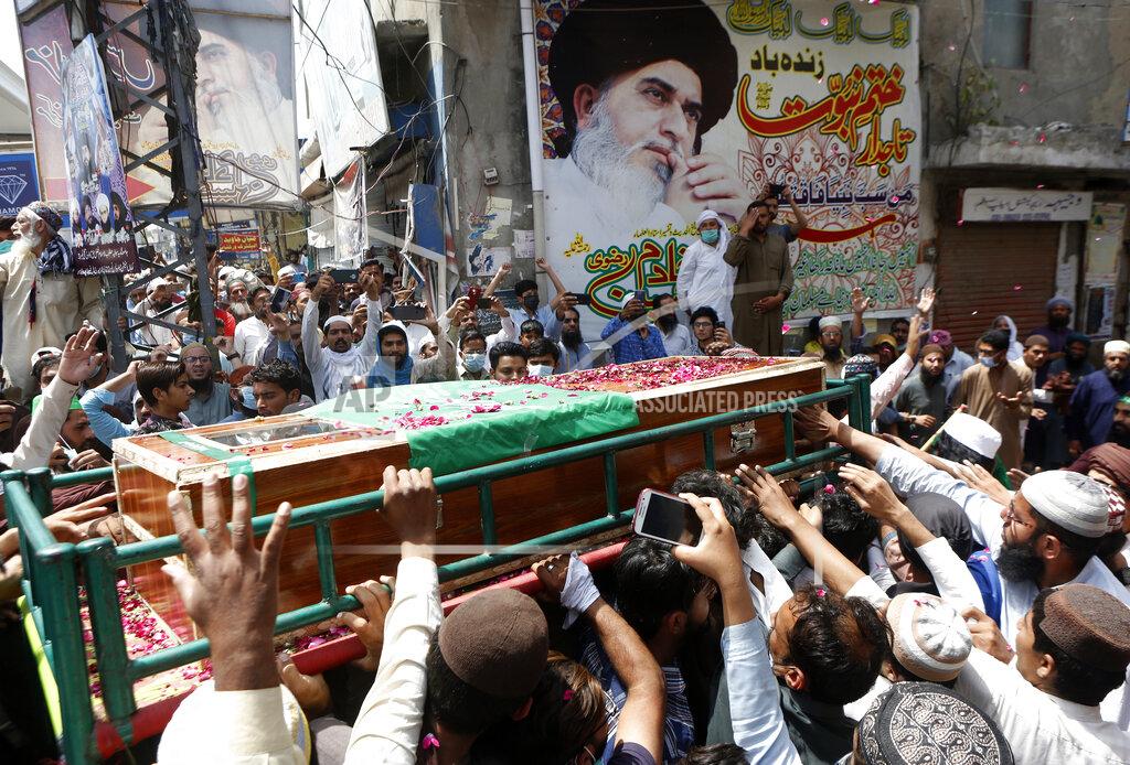 K.M. Chaudary Supporters of Tehreek-e-Labiak Pakistan, a banned Islamist party, carry a casket of their colleague, who was killed in the Sunday's clash with police, for a funeral prayer, in Lahore, Pakistan, Monday, April 19, 2021. The outlawed Pakistani Islamist political group freed 11 policemen almost a day after taking them hostage in the eastern city of Lahore amid violent clashes with security forces, the country's interior minister said Monday. (AP Photo/K.M. Chaudary)