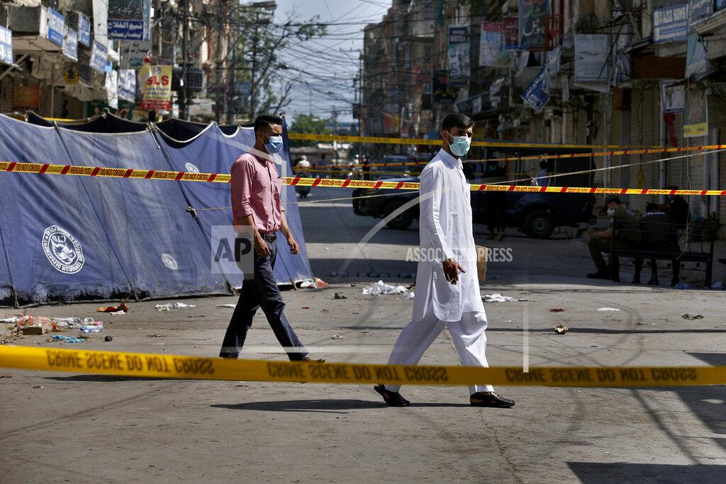Anjum Naveed Pakistani investigators examine at the site of Friday's bomb explosion in Rawalpindi, Pakistan, Saturday, June 13, 2020. A powerful bomb exploded at a crowded bazaar in the Pakistani garrison city of Rawalpindi on Friday, killed and wounded some persons, police and government officials said. (AP Photo/Anjum Naveed)