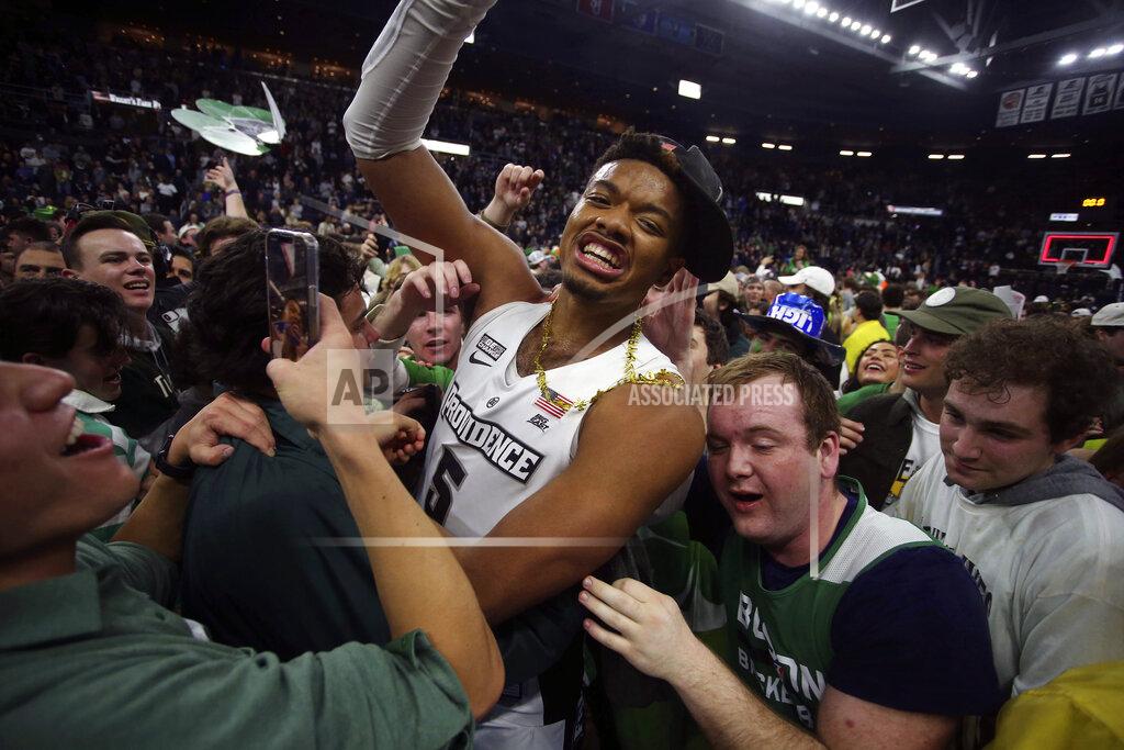 Stew Milne Providence's Ed Croswell (5) is surrounded by fans after an NCAA college basketball game against Creighton, Saturday, Feb. 26, 2022, in Providence, R.I. Providence won the regular season Big East title. (AP Photo/Stew Milne)