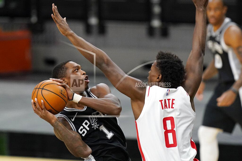 Eric Gay San Antonio Spurs guard Lonnie Walker IV (1) drives to the basket against Houston Rockets forward Jae'Sean Tate (8) during the first half of an NBA basketball game in San Antonio, Thursday, Jan. 14, 2021. (AP Photo/Eric Gay)