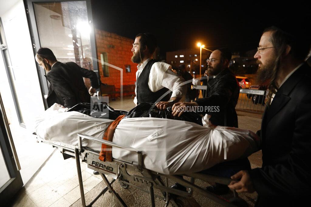 Ariel Schalit The body of Menachem Knoblowitz, 21, from the United States, who died during Lag BaOmer celebrations at Mt. Meron in northern Israel, arrives for his funeral in Jerusalem on Saturday, May 1 2021. A stampede at a religious festival attended by tens of thousands of ultra-Orthodox Jews in northern Israel killed dozens of people and injured about 150 early Friday, medical officials said. It was one of the country's deadliest civilian disasters. (AP Photo/Ariel Schalit)