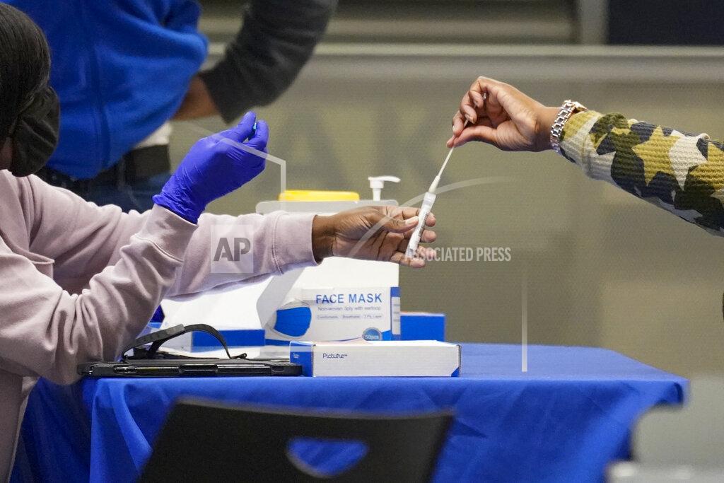 Mary Altaffer A travelers places a swab in a tube after self testing for COVID-19 at a NYC Health + Hospitals mobile testing site, Tuesday, Nov. 24, 2020, in New York's Penn Station. Gov. Andrew Cuomo urged New Yorkers to just say no to Thanksgiving gatherings to help reduce COVID-19 infections and hospitalizations, which he said are rising at a dangerous level. (AP Photo/Mary Altaffer)