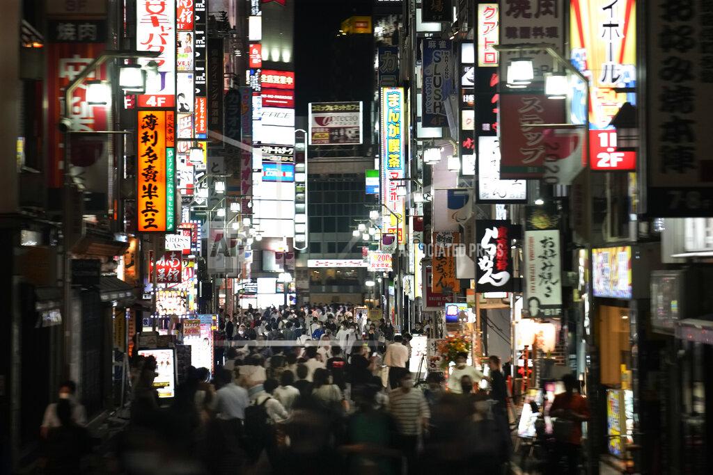 Jae C. Hong People crowd the street in the Kabukicho area, Tokyo's entertainment district, Friday, July 16, 2021, in Tokyo. Tokyo is under a fourth state of emergency, which began Monday and requires restaurants and bars to close early and not serve alcohol through the 2020 Summer Olympics, which start July 23. (AP Photo/Jae C. Hong)